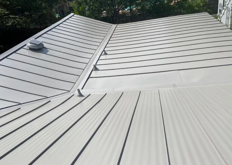 Solar attic fan installed on a metal roof for Roof Ventilation in Upper Grand Lagoon